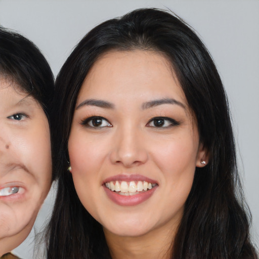 Joyful asian young-adult female with long  black hair and brown eyes