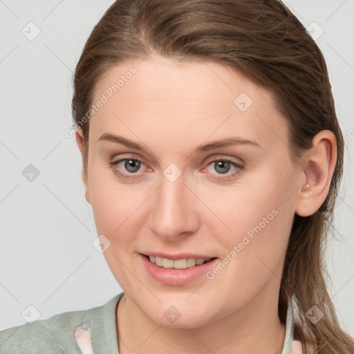 Joyful white young-adult female with medium  brown hair and blue eyes