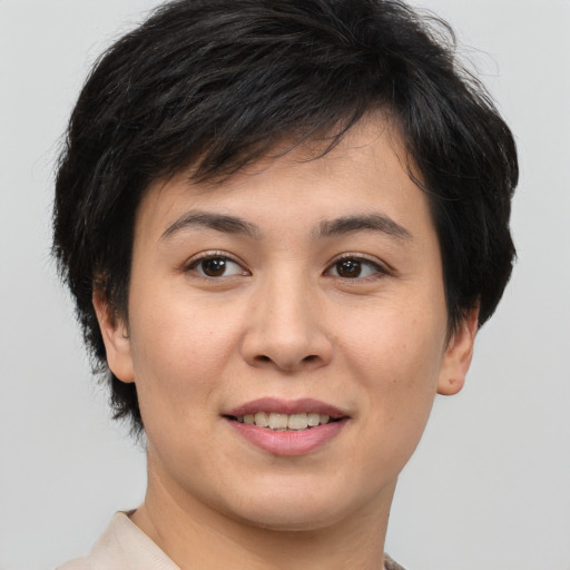 Joyful asian young-adult female with short  brown hair and brown eyes