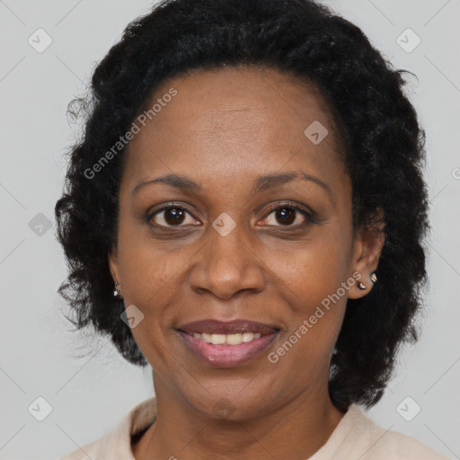 Joyful black adult female with long  brown hair and brown eyes