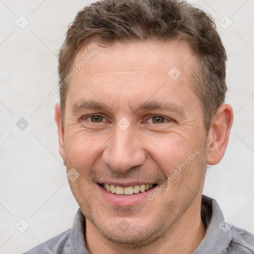 Joyful white adult male with short  brown hair and brown eyes