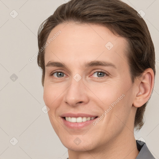 Joyful white young-adult female with medium  brown hair and grey eyes