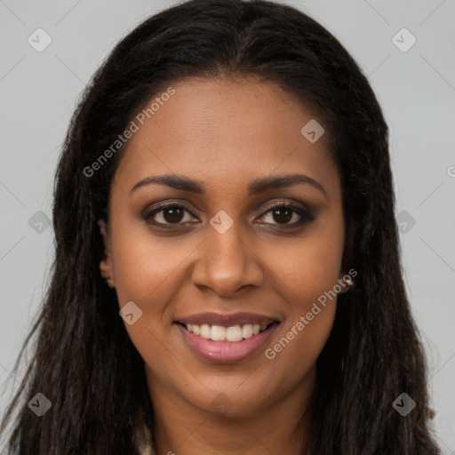 Joyful black young-adult female with long  brown hair and brown eyes