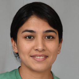 Joyful latino young-adult female with medium  brown hair and brown eyes