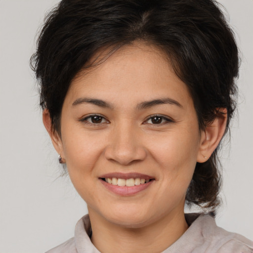 Joyful asian young-adult female with medium  brown hair and brown eyes