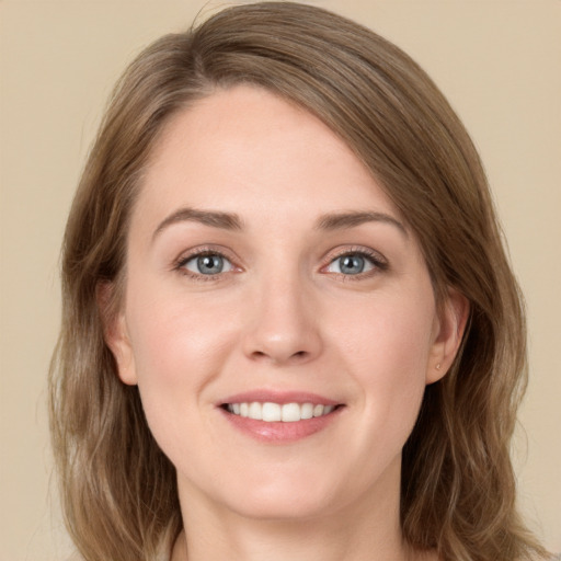 Joyful white young-adult female with long  brown hair and green eyes