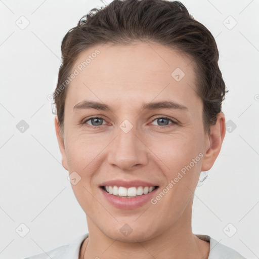 Joyful white young-adult female with short  brown hair and grey eyes