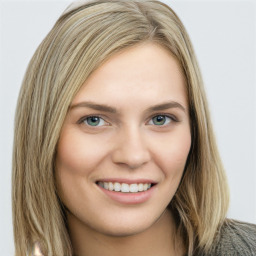 Joyful white young-adult female with long  brown hair and green eyes