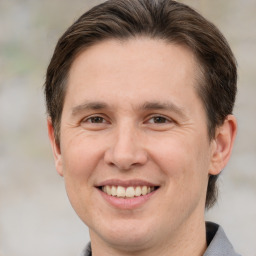 Joyful white adult male with short  brown hair and brown eyes