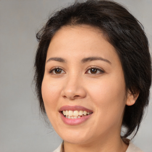 Joyful white young-adult female with medium  brown hair and brown eyes