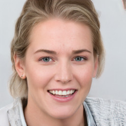 Joyful white young-adult female with medium  brown hair and blue eyes