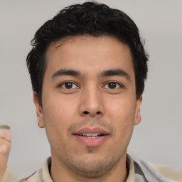 Joyful latino young-adult male with short  brown hair and brown eyes