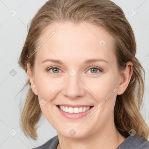 Joyful white young-adult female with medium  brown hair and blue eyes