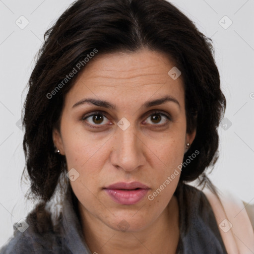 Joyful white adult female with long  brown hair and brown eyes