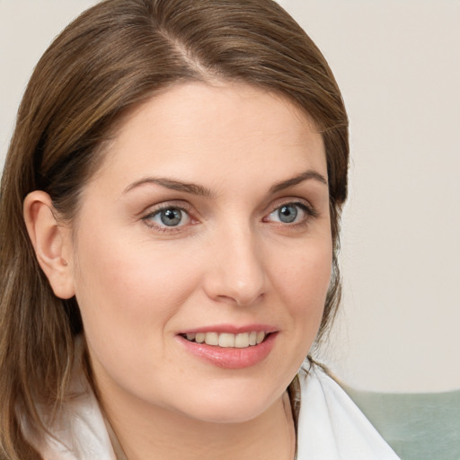 Joyful white young-adult female with medium  brown hair and blue eyes