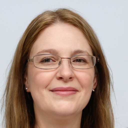 Joyful white adult female with long  brown hair and grey eyes