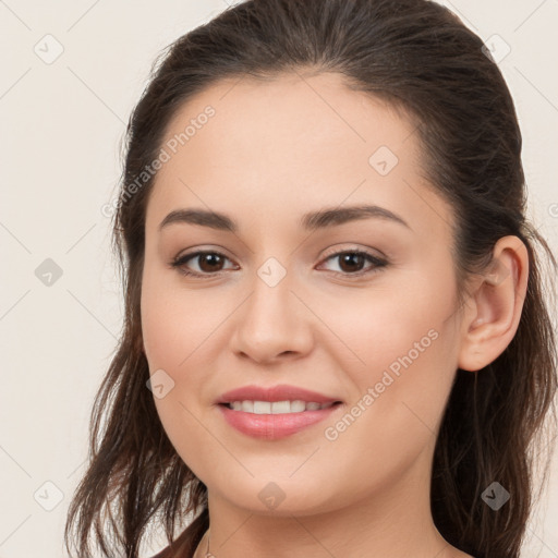 Joyful white young-adult female with long  brown hair and brown eyes