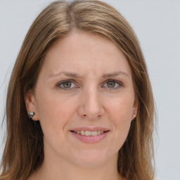 Joyful white adult female with long  brown hair and grey eyes