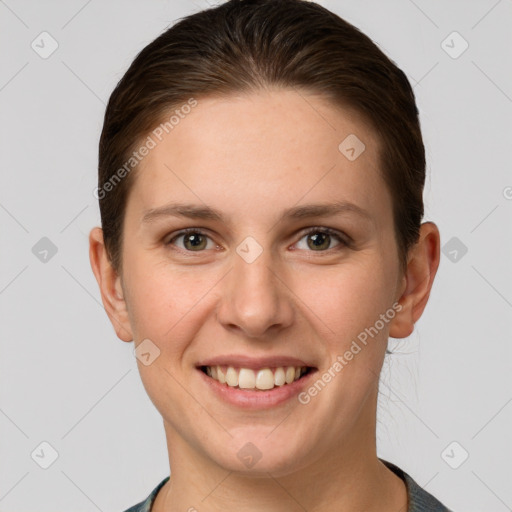 Joyful white young-adult female with short  brown hair and grey eyes