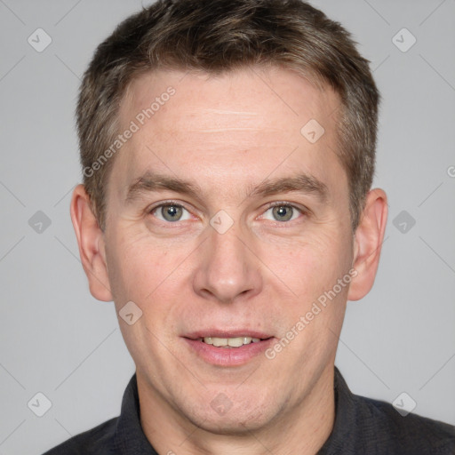 Joyful white adult male with short  brown hair and grey eyes