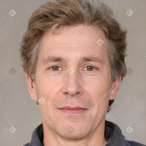 Joyful white adult male with short  brown hair and grey eyes