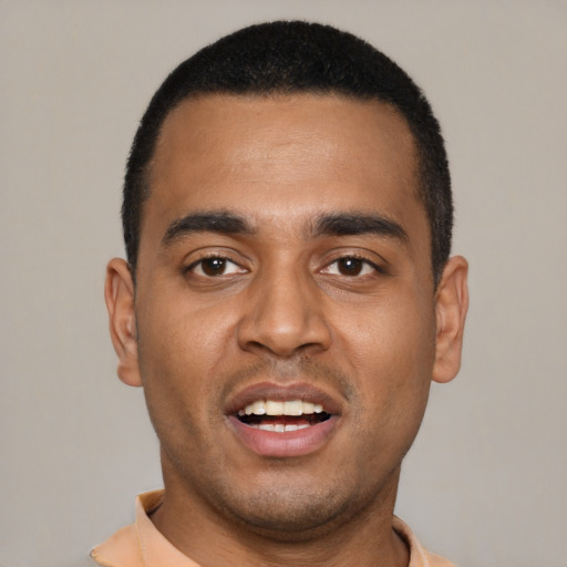 Joyful black young-adult male with short  black hair and brown eyes