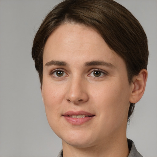 Joyful white young-adult female with short  brown hair and grey eyes