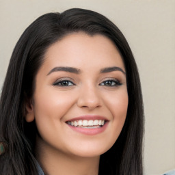 Joyful white young-adult female with long  black hair and brown eyes