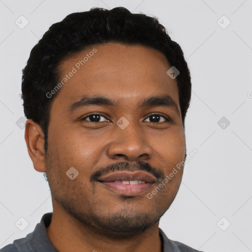 Joyful black young-adult male with short  black hair and brown eyes