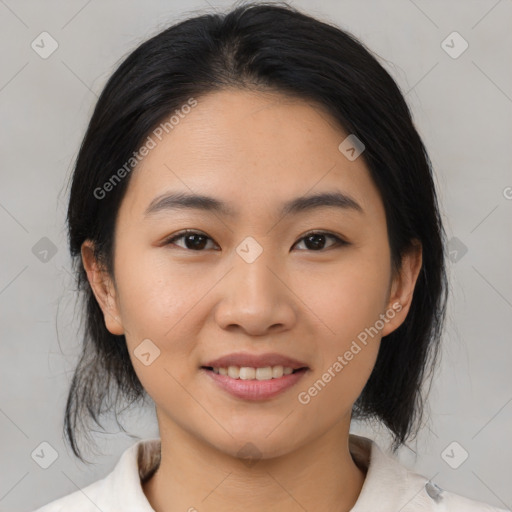 Joyful asian young-adult female with medium  black hair and brown eyes