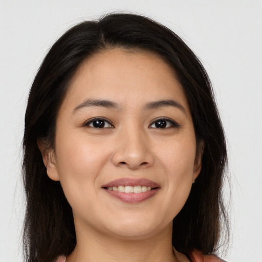 Joyful white young-adult female with long  brown hair and brown eyes