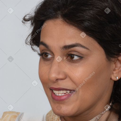 Joyful white adult female with medium  brown hair and brown eyes