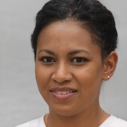 Joyful latino young-adult female with short  brown hair and brown eyes