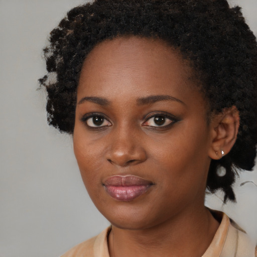Joyful black young-adult female with medium  black hair and brown eyes