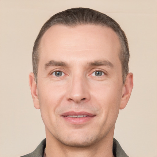 Joyful white adult male with short  brown hair and grey eyes