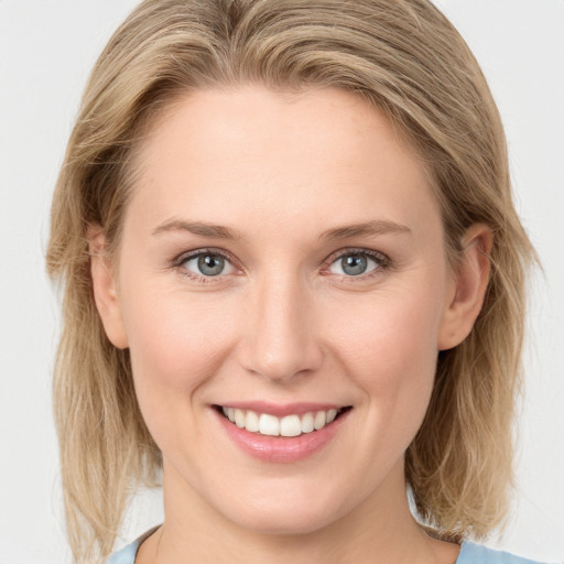 Joyful white young-adult female with medium  brown hair and blue eyes