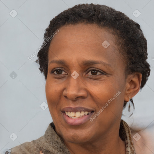 Joyful black adult female with short  brown hair and brown eyes