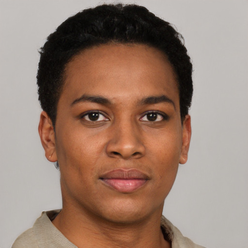 Joyful black young-adult male with short  black hair and brown eyes