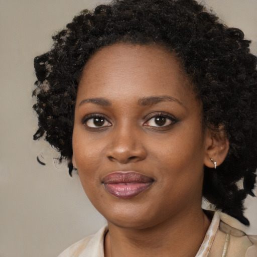 Joyful black young-adult female with medium  black hair and brown eyes