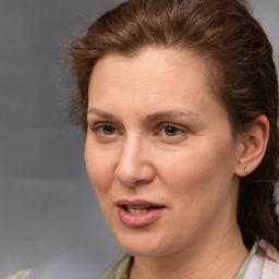 Joyful white adult female with medium  brown hair and grey eyes