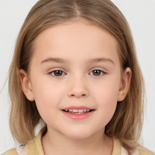 Joyful white child female with medium  brown hair and brown eyes