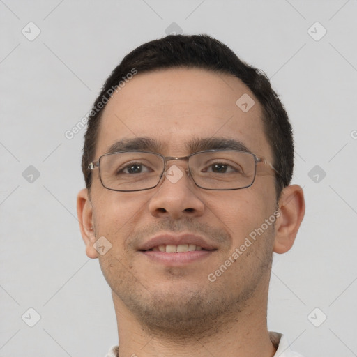 Joyful white young-adult male with short  black hair and brown eyes