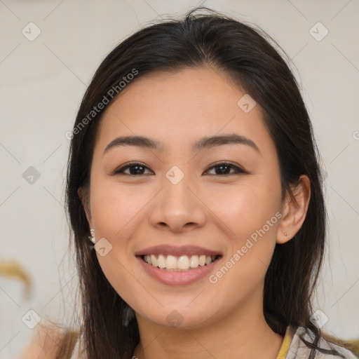 Joyful latino young-adult female with medium  brown hair and brown eyes