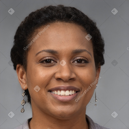 Joyful black young-adult female with short  brown hair and brown eyes