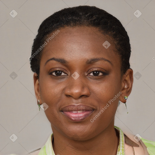 Joyful black young-adult female with short  brown hair and brown eyes