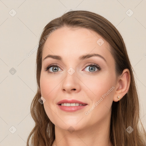 Joyful white young-adult female with long  brown hair and blue eyes