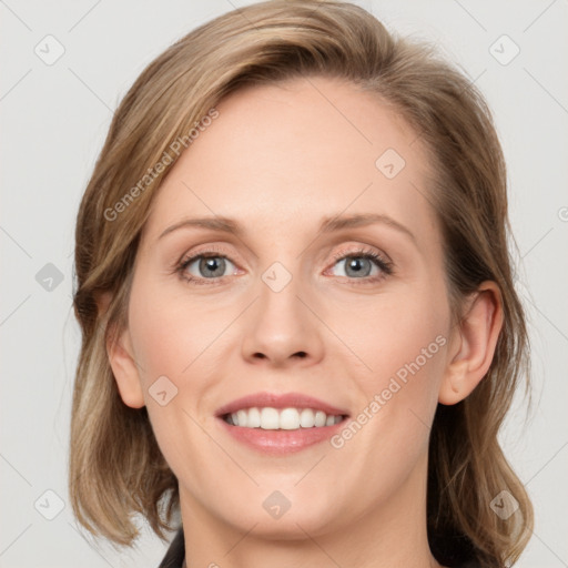 Joyful white young-adult female with medium  brown hair and blue eyes