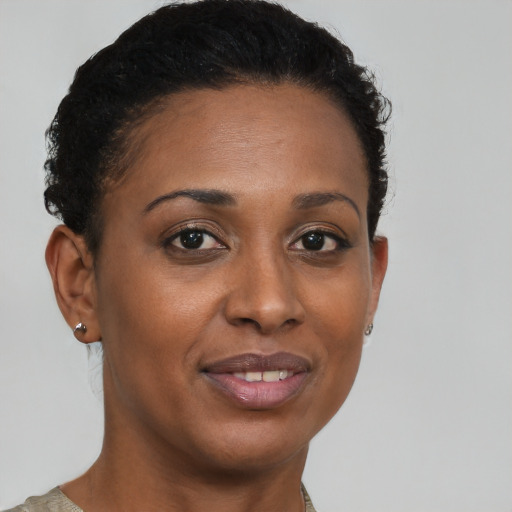 Joyful black young-adult female with short  brown hair and brown eyes