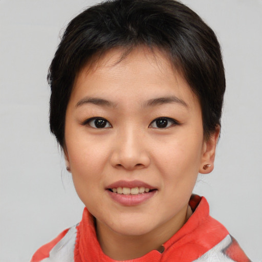 Joyful asian young-adult female with short  brown hair and brown eyes