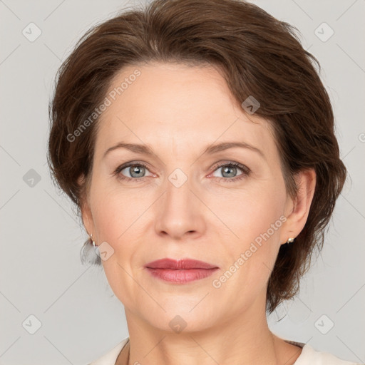 Joyful white adult female with medium  brown hair and grey eyes